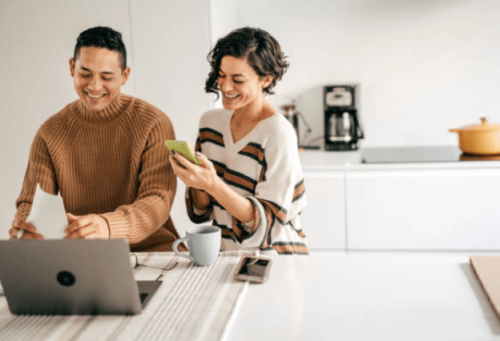 family holiday budget man and woman looking at devices